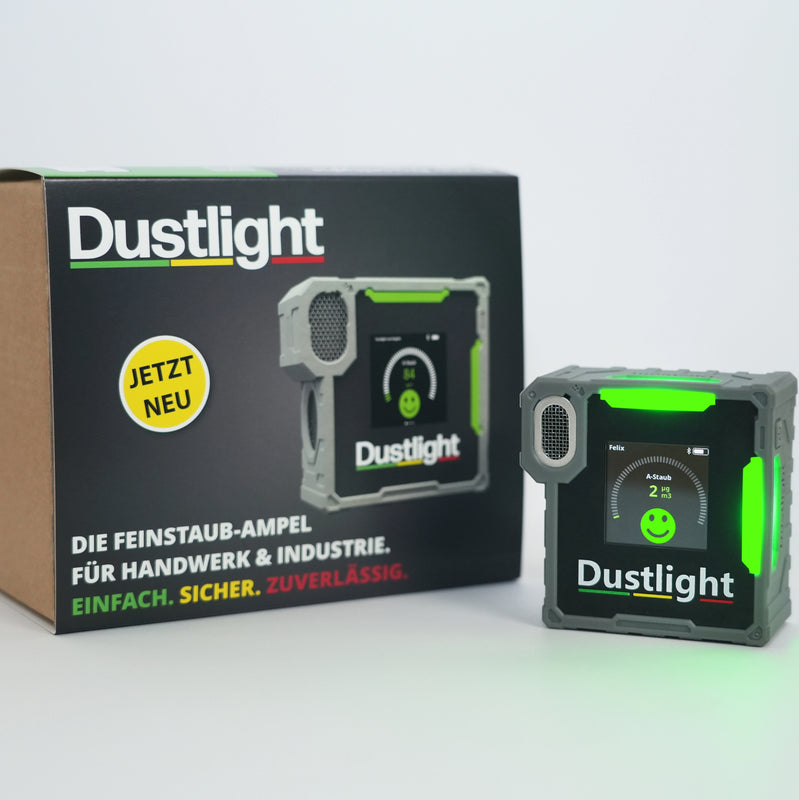 Dustlight A-Staub Messgerät zur Überwachung der Luftqualität am Arbeitsplatz, robust und tragbar für den industriellen Einsatz. Grüne LED deutet auf eine Staubexposition unter dem Schwellwert hin.